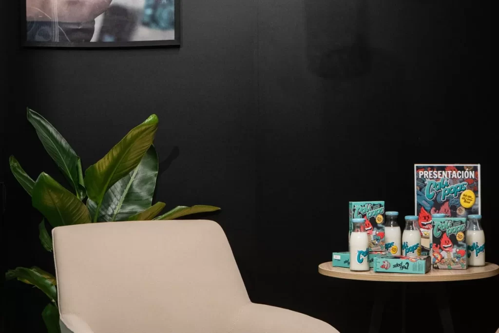 Modern exhibition stand display with seating and branded decor