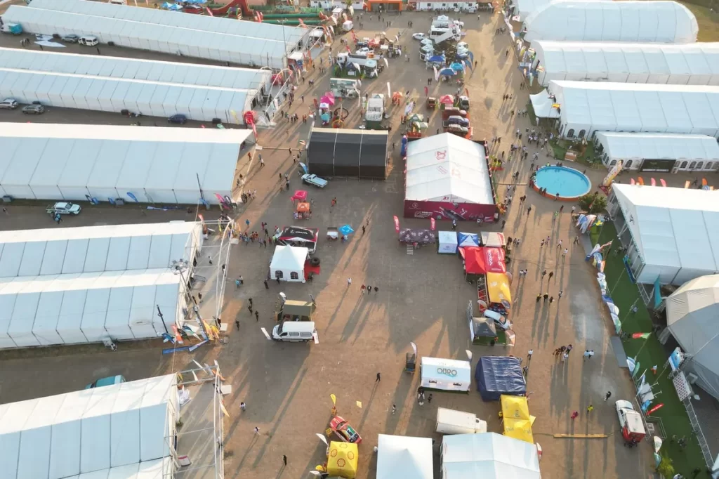 Aerial view of an outdoor event with tents and gazebos